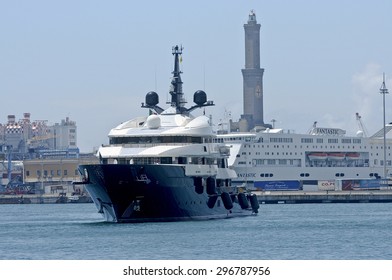 Genoa, Italy - June 10, 2015: Steven Spielberg Yacht, The Seven Seas, Get To The Port Of Genoa. In The Background The Lighthouse Of The City, The Symbol Of Genoa. 