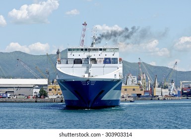 GENOA, ITALY - JUNE 15, 2014: Eurocargo Malta Is A RoRo Ferry Cargo Company Inarme The Grimaldi Group, Built In Hyundai Mipo Shipyard In Ulsan, South Korea.
The Ship Enters The Port. 