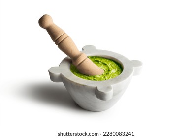 Genoese pesto sauce with mortar and ingredients isolated on white background