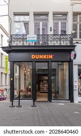 Gent, Flanders, Belgium - July 30, 2021: Dunkin Donuts Store Black And Window Facade On Corner Showing Display Inside And Advertising As DD. 