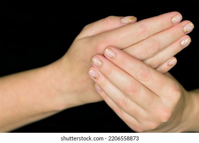 Gentle Aesthetic Trendy Manicure On Short Nails With Transparent Gel Polish With Decor Pieces Of Gold Foil Close-up On Fingernails On Two Hands On A Black Background