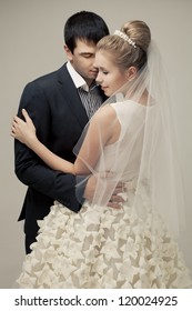 Gentle Couple Of Lovers Groom And Bride. Studio Shooting At White Background