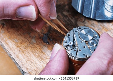 With a gentle grip, the watchmaker handles a small piece on a watch movement, emphasizing the steady hand and focus required to align components in intricate watch repairs - Powered by Shutterstock