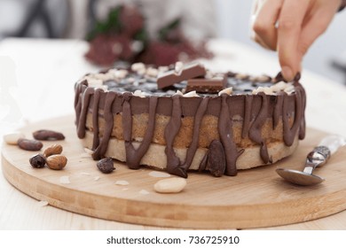 A Gentle Hand Decorating Raw Vegan Snickers Cake.