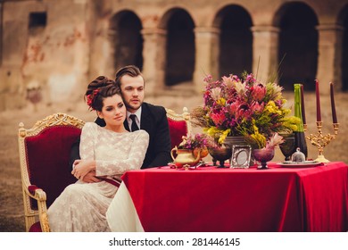 Gentle And Loving Couple Sitting At A Table In An Old Mansion.  Autumn