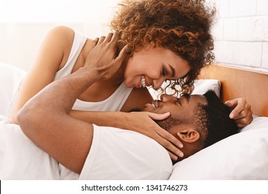 Gentle morning together. Young black couple making love in bed, start day with passion, closeup