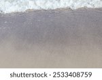 Gentle Ocean Waves Touching Sandy Shoreline in Minimalist Coastal Scene