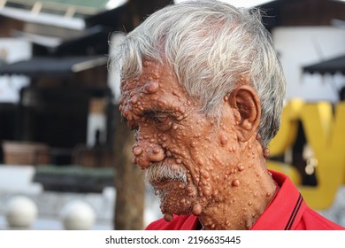 Gentle Old Man In Red Shirt