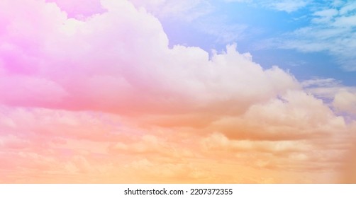 Gentle Pastel Rainbow Gradient  Of Blue, Yellow, Pink, Orange And Light Green  Blend Softly And Subtle On The Atmospheric Background Of The Natural Sky.  With A Beautiful Mist With A Faint White Cloud