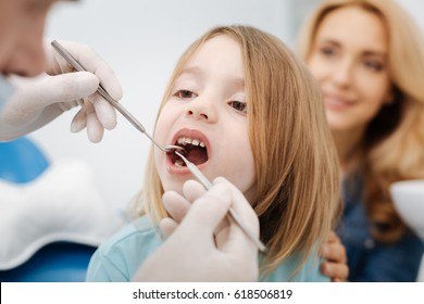 Gentle Pediatric Dentist Doing A Checkup