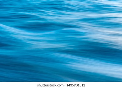 Gentle Soothing Silky Flowing Natural Ocean Water Movement. Abstract Background Motion Blur. Serene And Peaceful Deep Blue Sea In Nature.