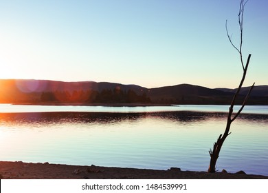 Gentle Sunset Over Jindabyne Lake Still Waters Of Snowy Mountains National Park In NSW, Australia.