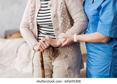 Gentle trained nurse helping mature patient