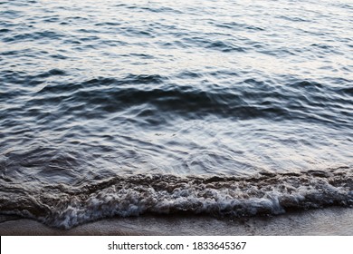 Gentle Wave Laps Shore With Cool Colors And Tones