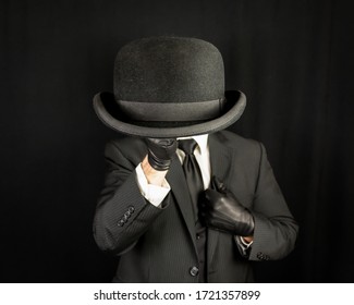 Gentleman In Dark Suit Holding Bowler Hat. Concept Of Classic And Eccentric British Gentleman Stereotype. Stylish Suit And Hat. Vintage Style And Retro Fashion.