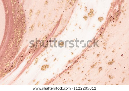 Gently pink color. Fresh painting on the water. Luxury art in Eastern style. Golden swirl, artistic design. Painter uses vibrant paints to create these magic art, with addition golden glitters, lines.