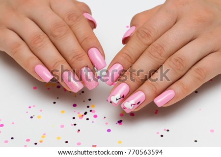 gently pink manicure with sparkles with painted hearts and arrows on square long nails

