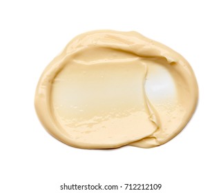 Gently yellow smear of face cream  isolated on white background. Gently yellow creamy texture