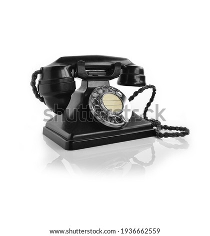 A genuine British authentic telephone from the 1940's, made from bakelite in black. Shot in high-resolution against a white background to allow addition of generous accommodation for copy space.