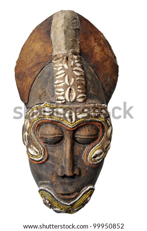 Genuine expressive African mask showing a typical face.Wood and leather materials, with shells decor.