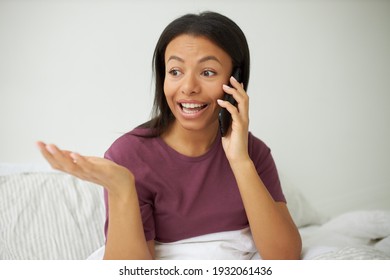 Genuine Human Reactions, Feelings And Technology. Headshot Of Amazed Attractive Young Black Woman Raising Eyebrows, Making Surprised Gesture, Gasping, Expressing Astonishment, Talking On Cell Phone