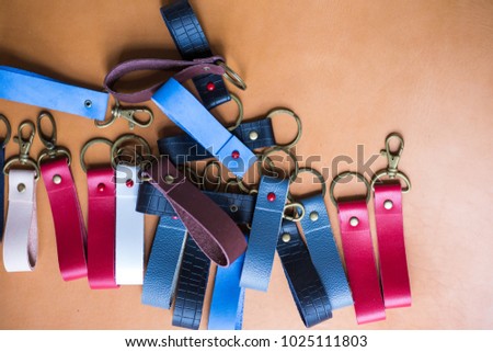 Genuine leather color keychain with metal head on leather background