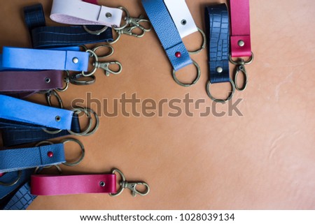 Genuine leather color keychain with metal head on leather background