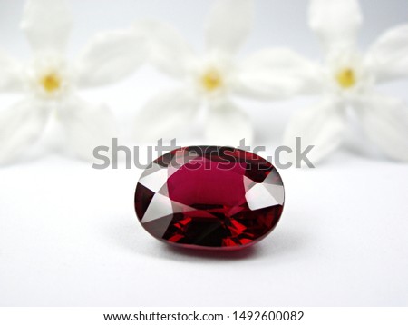 genuine mined natural red ruby oval shape cutting with white flower background