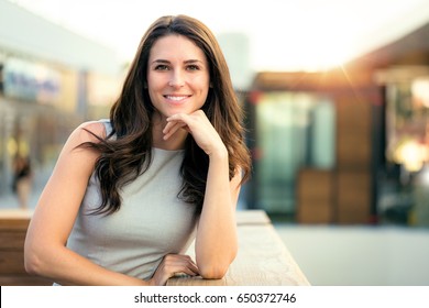 Genuine Natural Portrait Of Brunette Woman Happy And Smiling On Rooftop Of New Modern Home