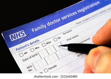 Genuine UK NHS Family Doctor Services Registration Form And Patient Filling It. GMS1 Form With PATIENTS DETAILS. United Kingdom, Stafford, December 18, 2021.