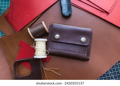 Genuine vegetable tanned leather working leather wallet on leather background craftmanship - Powered by Shutterstock