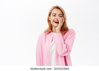 Genuine Young Woman Laughing, Touching Face And Smiling Sincere, Standing Over White Background