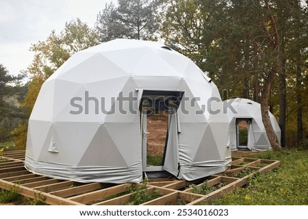 Geodesic domes for glamping and camping, thin-shell structure lattice shell based on geodesic polyhedron. Glamping is glamorous and camping, style of camping with amenities and resort style services.
