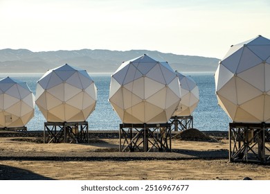 geodesic domes, satellite communication, Arctic, Greenland, technology, coastal landscape, scientific research, satellite station, remote location, modern infrastructure, antennas - Powered by Shutterstock