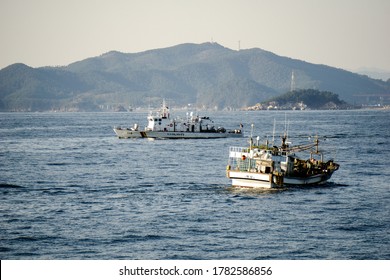 GEOJE, SOUTH KOREA - OCTOBER 20, 2018: Haenuri Class Hull Number 116, The South Korea Coast Guard Patrol Boat Sails Pass The Fishing Boat Near Geoje Island Coast.