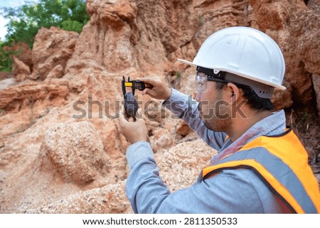 Geological Engineer Performing Site Documentation at Sedimentary Rock Outcrop Location