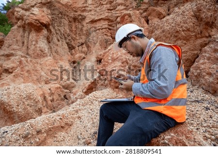 Geological Engineer Performing Site Documentation at Sedimentary Rock Outcrop Location