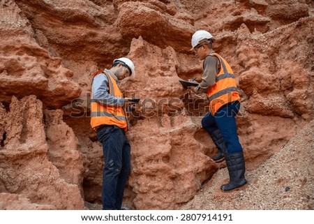 Geological Engineering Team Performing Rock Sample Analysis at Exploration Location