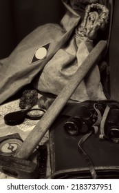 Geological fieldwork tools: map case, geological hammer, compass, magnifying glass, pocket knife, binoculars, storm jacket, drill core, rock samples, topographic and geological maps