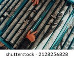 Geological gold core samples with team of mining workers measuring drilled rock top view. Selective focus 