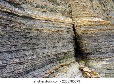 Geological Rock Layers Over Millions Of Years With A Small Entrance.