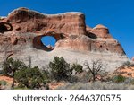 Geological sandstone formation Tunnel Arch with a big, tunnel-like hole in the middle along Devil