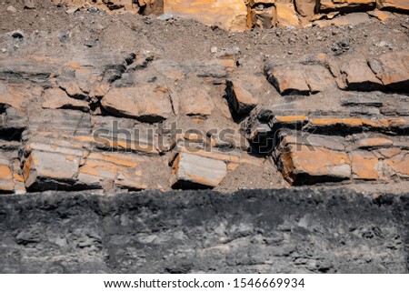 Geological section of soil, layers of coal and rock. Overburden open mine anthracite. Dark texture black color.