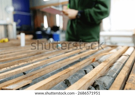 Geologist evaluating core samples in geological laboratory. Mining geology exploration of minerals.