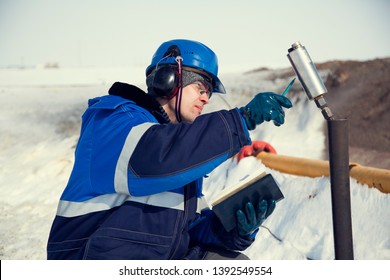 A Geologist Of Gas Wells Conducts Gas-dynamic Studies Of The Well, Measuring Temperature And Operating Pressure