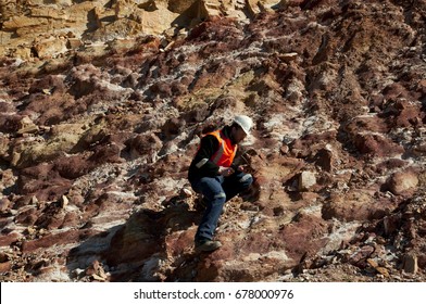 Geologist Hammering Rocks