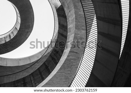 Geometric abstraction in the form of chaotic semicircles and arcs of different textures and from different materials. Black and white photo