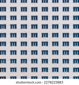 Geometric backdrop with lots of window rows. Simple classic design high-rise building. Realistic concept of office building. Apartment house texture background. Many windows on big wall close-up.