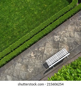 Geometric Background With A White Bench In A Green Park. Top View