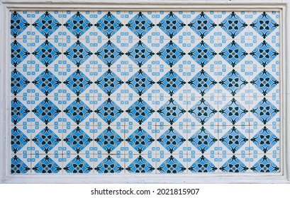 A geometric ceramic tile mosaic as typically found on the frontages of traditional chinese peranakan shop houses in Asia